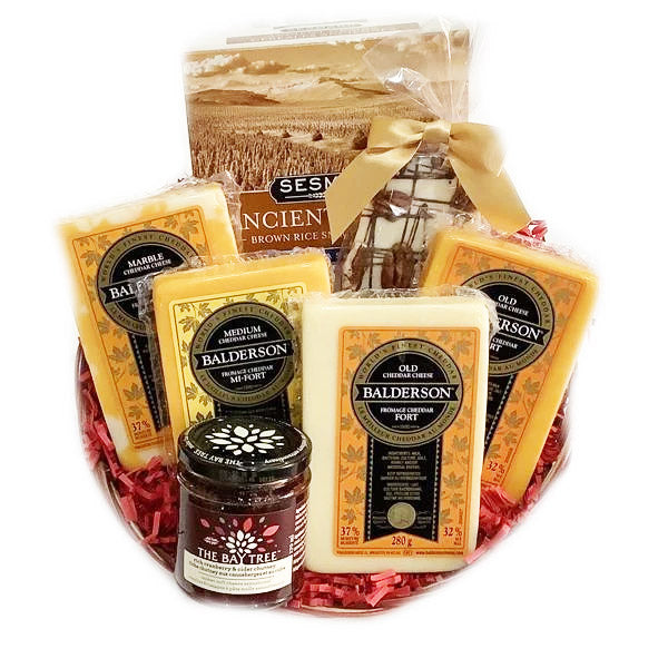 Gift basket filled with assorted Balderson cheddar cheeses, a jar of cranberry chutney, and crackers with a gold ribbon.