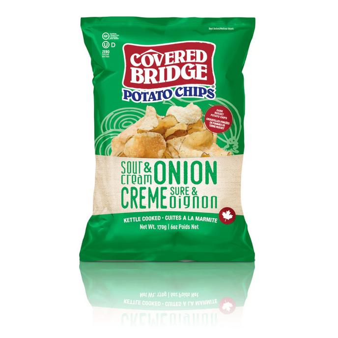 Covered Bridge Sour Cream & Onion Potato Chips bag, green and beige with a pile of chips.