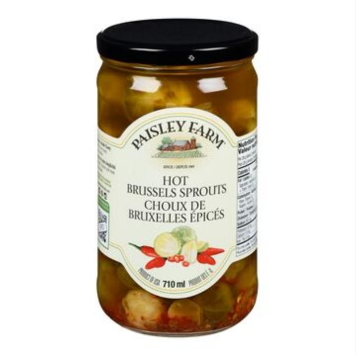 Paisley Farm 710ml jar of Hot Brussels Sprouts, with a black lid and white label featuring red chilies.