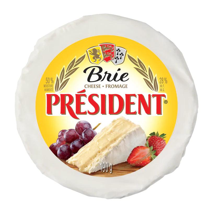 Round President Brie cheese, 190g, with a yellow label featuring grapes, strawberries, and a cut wedge.