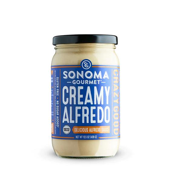 Sonoma Gourmet Creamy Alfredo sauce in a 439g glass jar with a black lid and blue and white label.