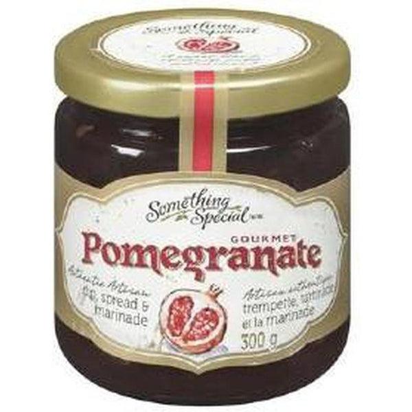Gourmet Pomegranate Spread in a clear glass jar with a gold lid and elegant label.