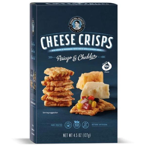 Macy's Asiago & Cheddar Cheese Crisps box with stacked crisps, cheese blocks, and a salsa-topped crisp.