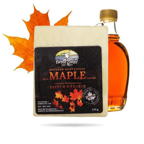 Block of Great Lakes Maple Cheddar Goat Cheese with a small maple syrup bottle and autumn maple leaves.